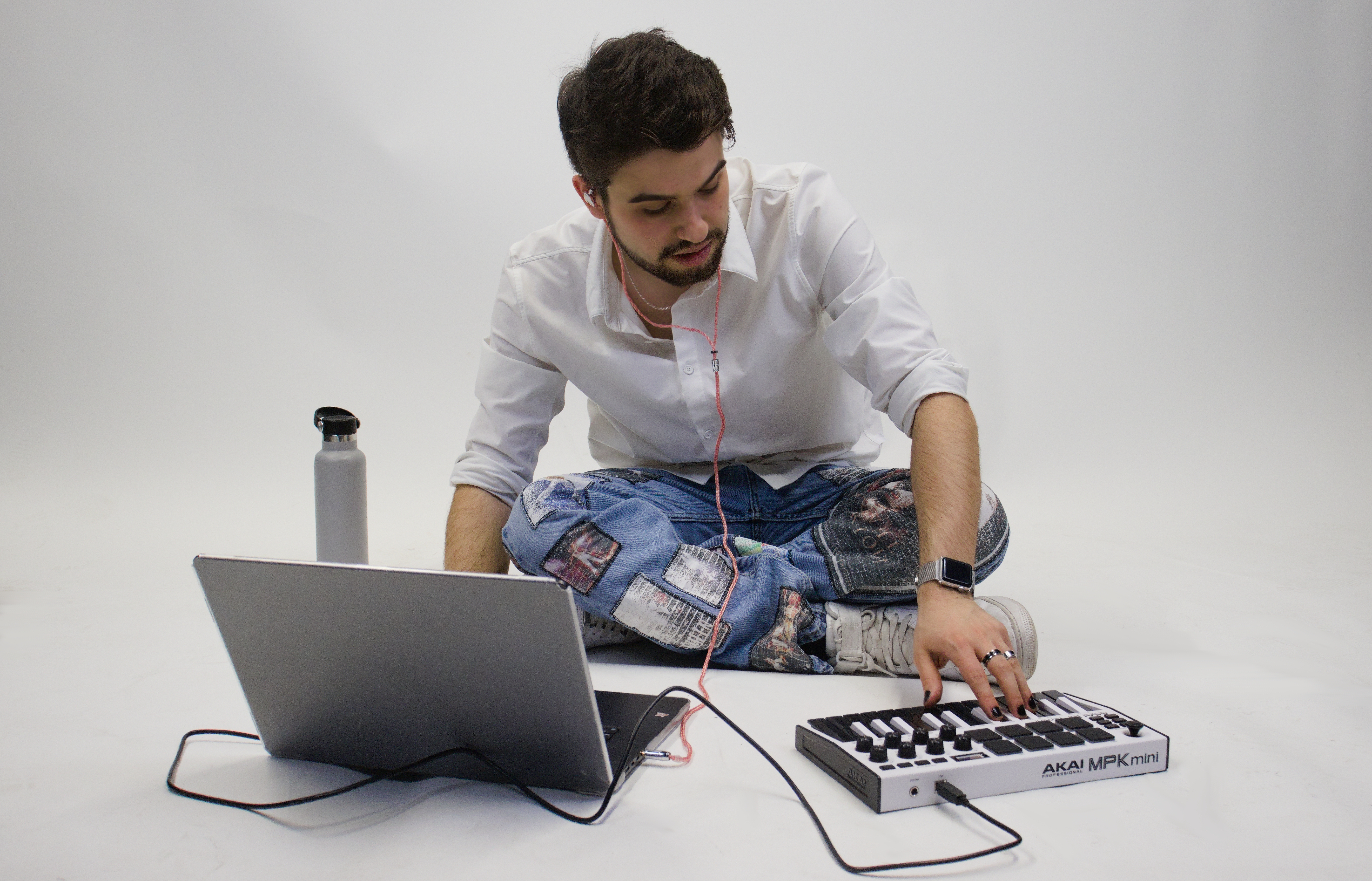 quinny sitting on ground playing a small keyboard